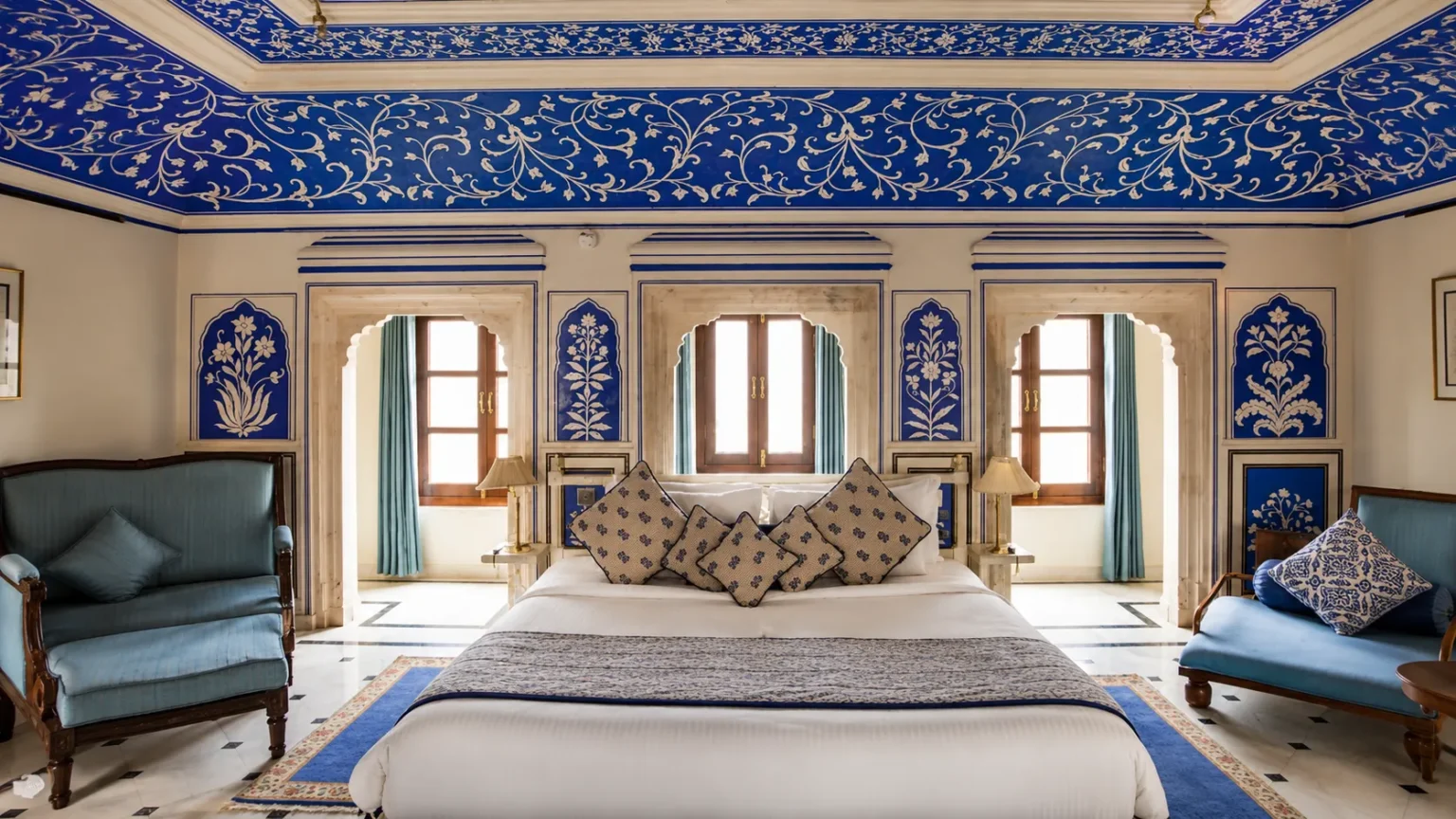 Entrance courtyard of Royal Heritage Haveli Jaipur with elegant architecture, landscaped gardens, and outdoor dining area.