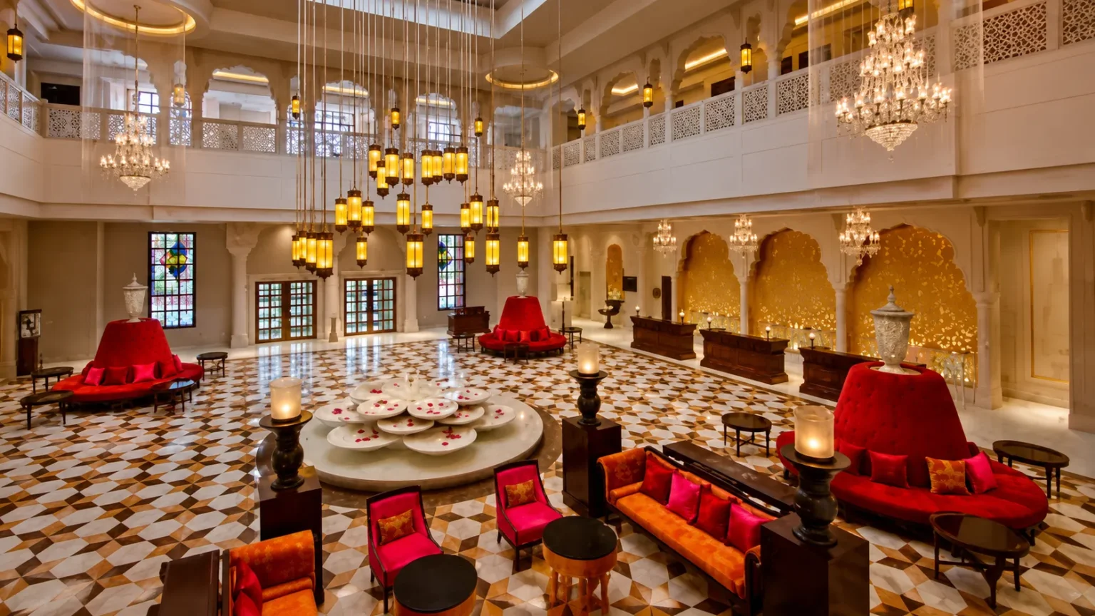 Elegant lobby of ITC Rajputana Jaipur featuring chandeliers, heritage décor, and luxurious seating areas.