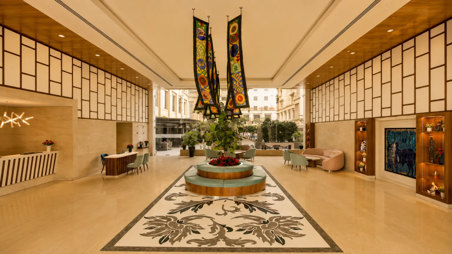 Comfortable seating area beside a large window overlooking lush greenery at Lemon Tree Hotel Delhi Airport.