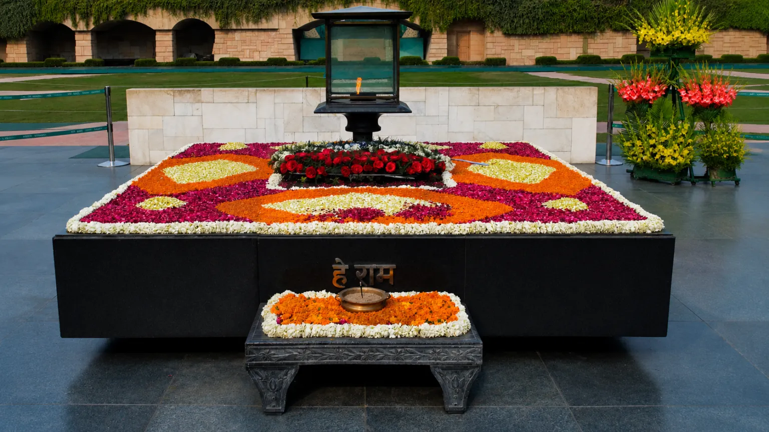 Eternal flame and floral tribute at Raj Ghat, the memorial dedicated to Mahatma Gandhi in New Delhi.