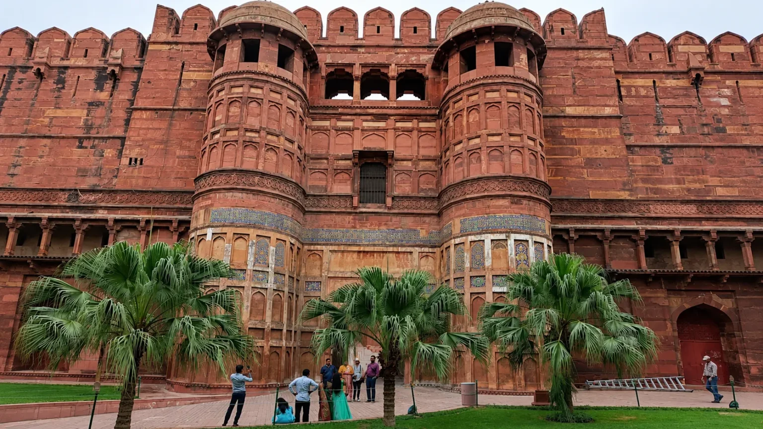 Massive red sandstone walls and grand entrance towers of Agra Fort, a UNESCO World Heritage Site in Uttar Pradesh, India.