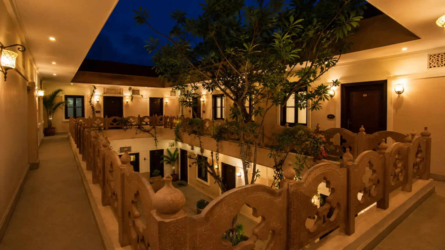 Heritage courtyard at Amritara Suryauday Haveli in Varanasi with traditional balconies, warm lighting, and classic architecture.