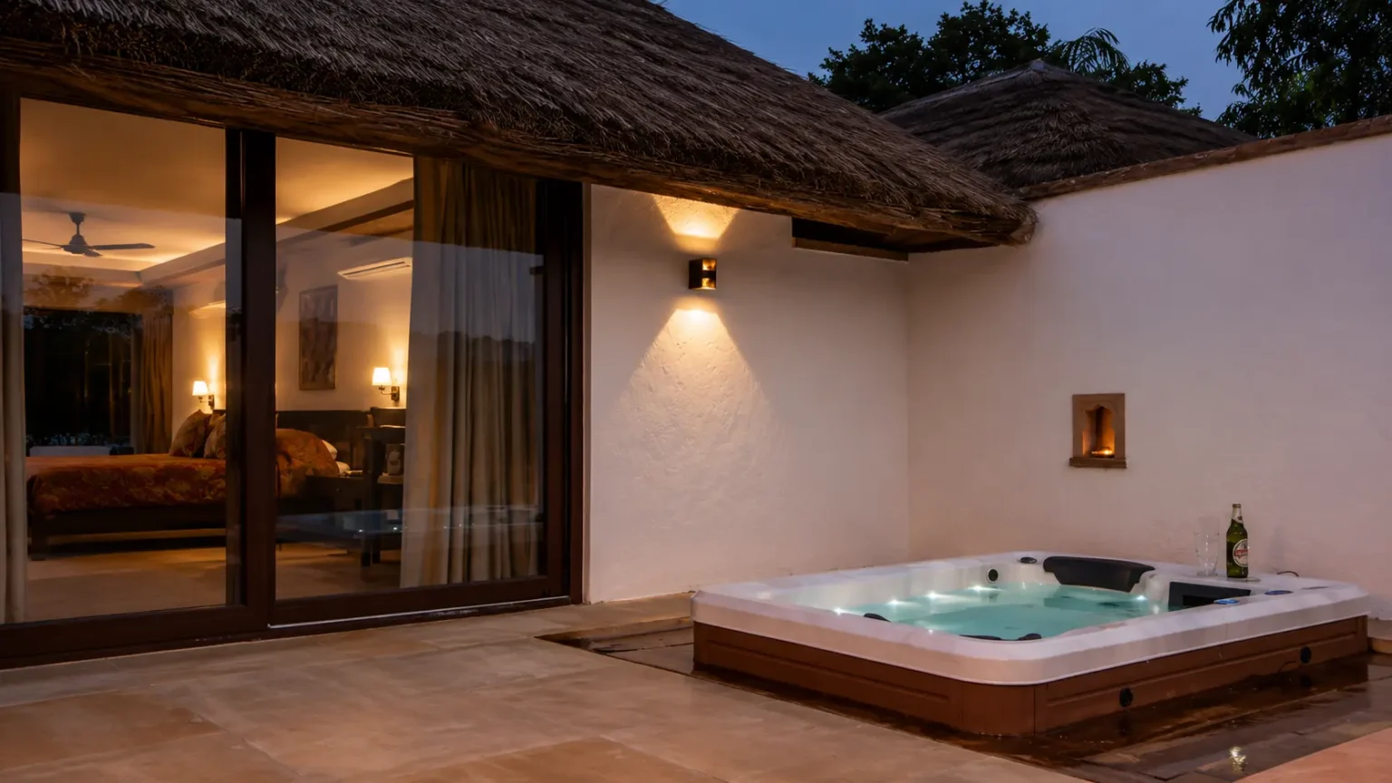 Private cottage patio at Khem Villas Ranthambore with comfortable seating, landscaped gardens, and stone architecture.