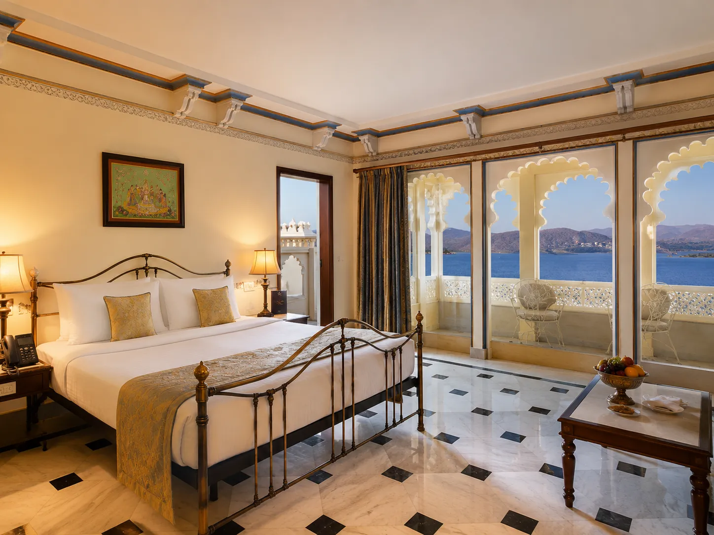 Elegant room at Taj Lake Palace featuring arched windows overlooking Lake Pichola.