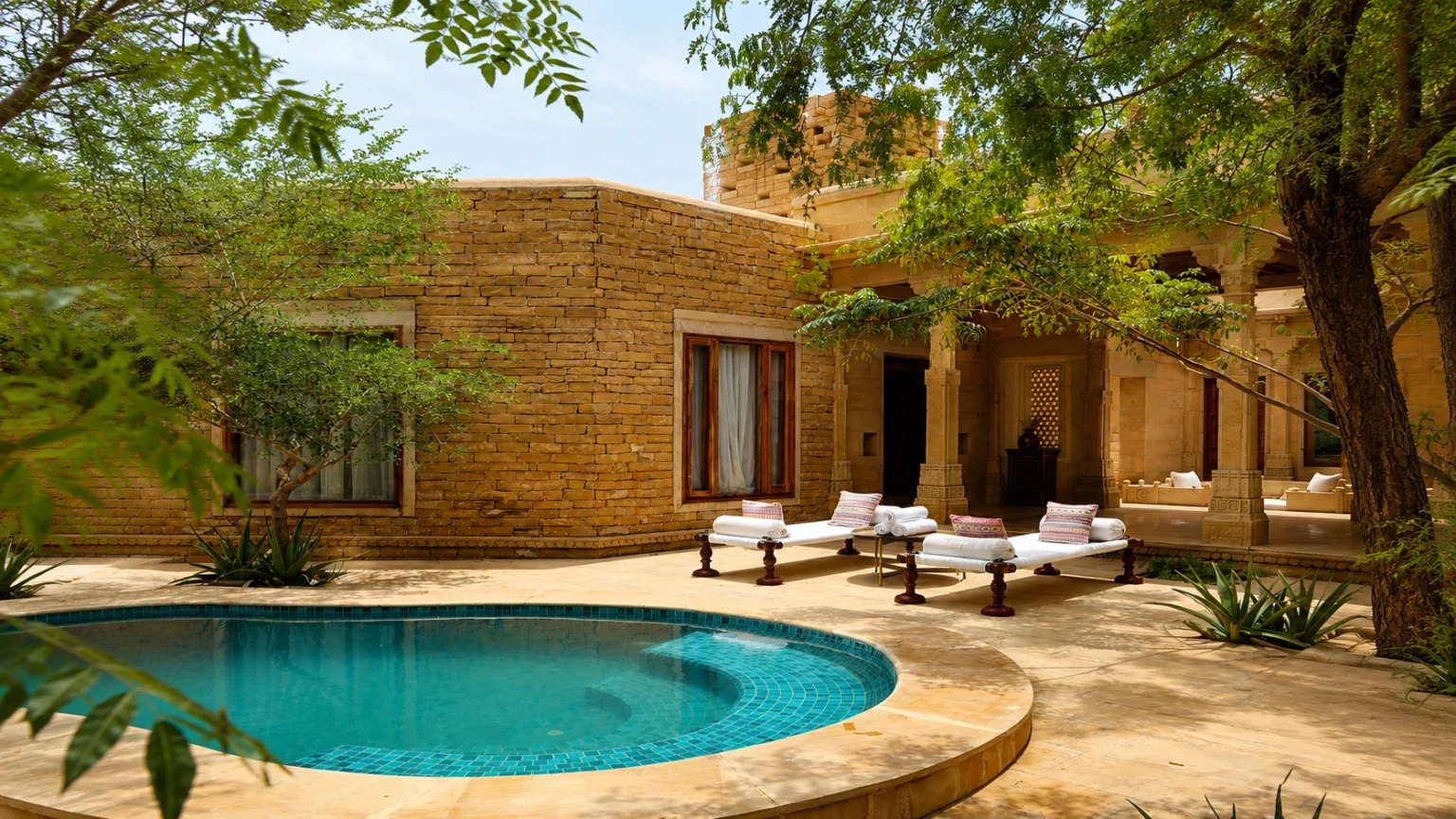 Private luxury pool villa at Suryagarh Jaisalmer featuring sandstone architecture, outdoor plunge pool and elegant lounge area in Rajasthan.
