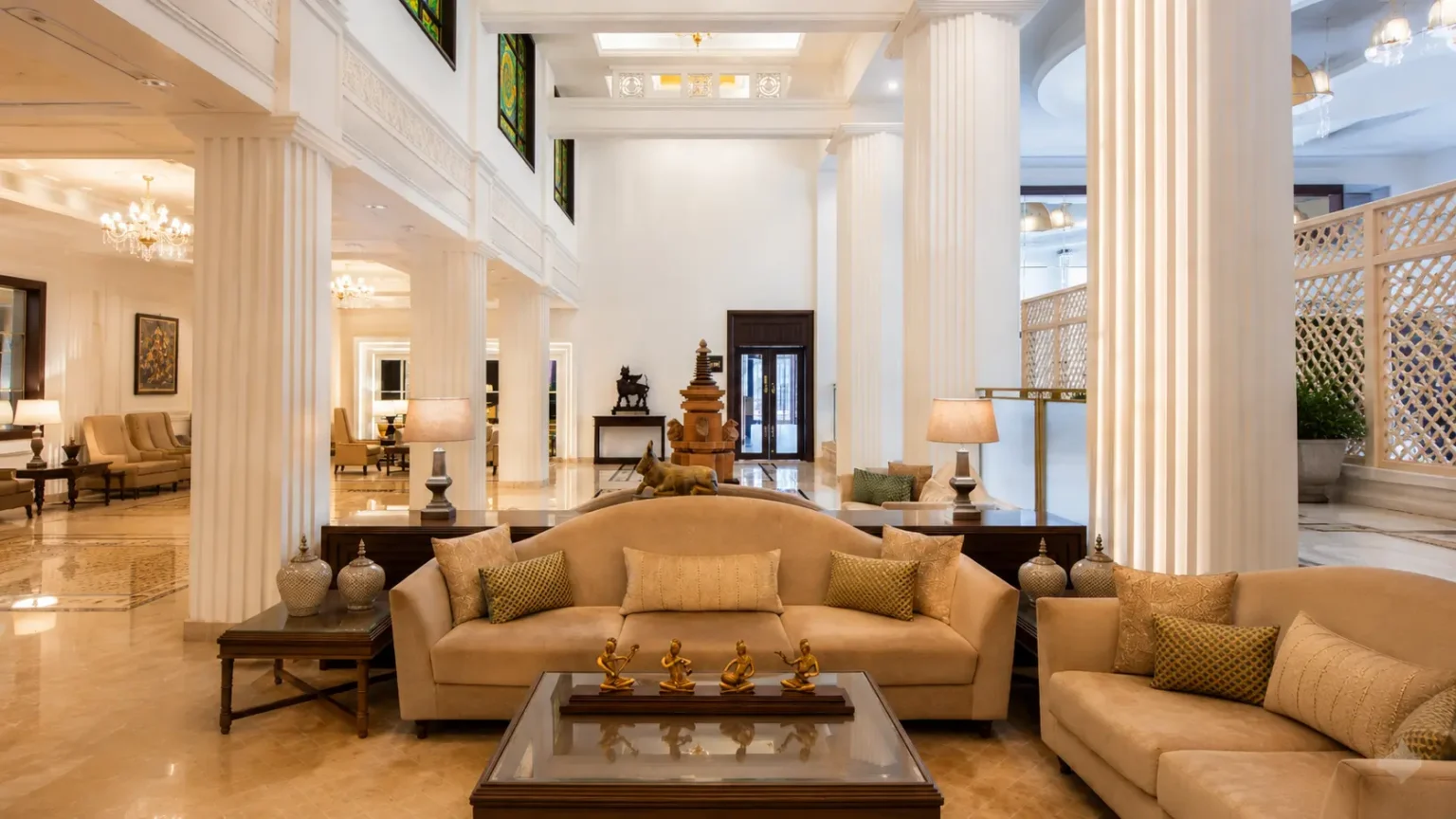 Spacious luxury lobby at Taj Ganges Varanasi with grand columns, elegant seating, and refined interiors.