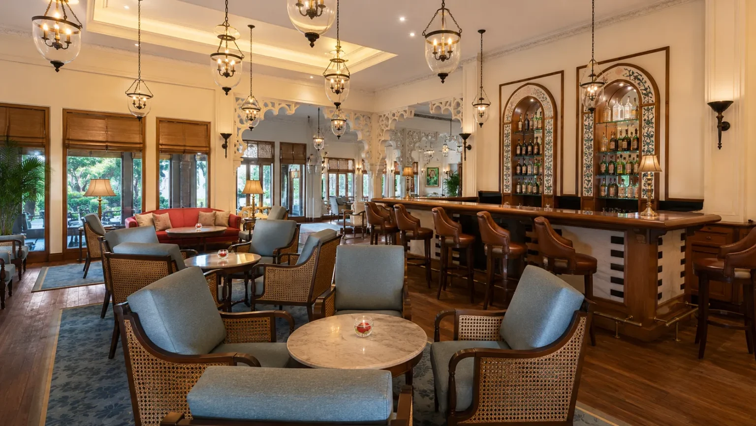 Stylish lounge bar at Trident Udaipur featuring elegant seating, handcrafted interiors, warm lighting, and a refined atmosphere for evening relaxation.