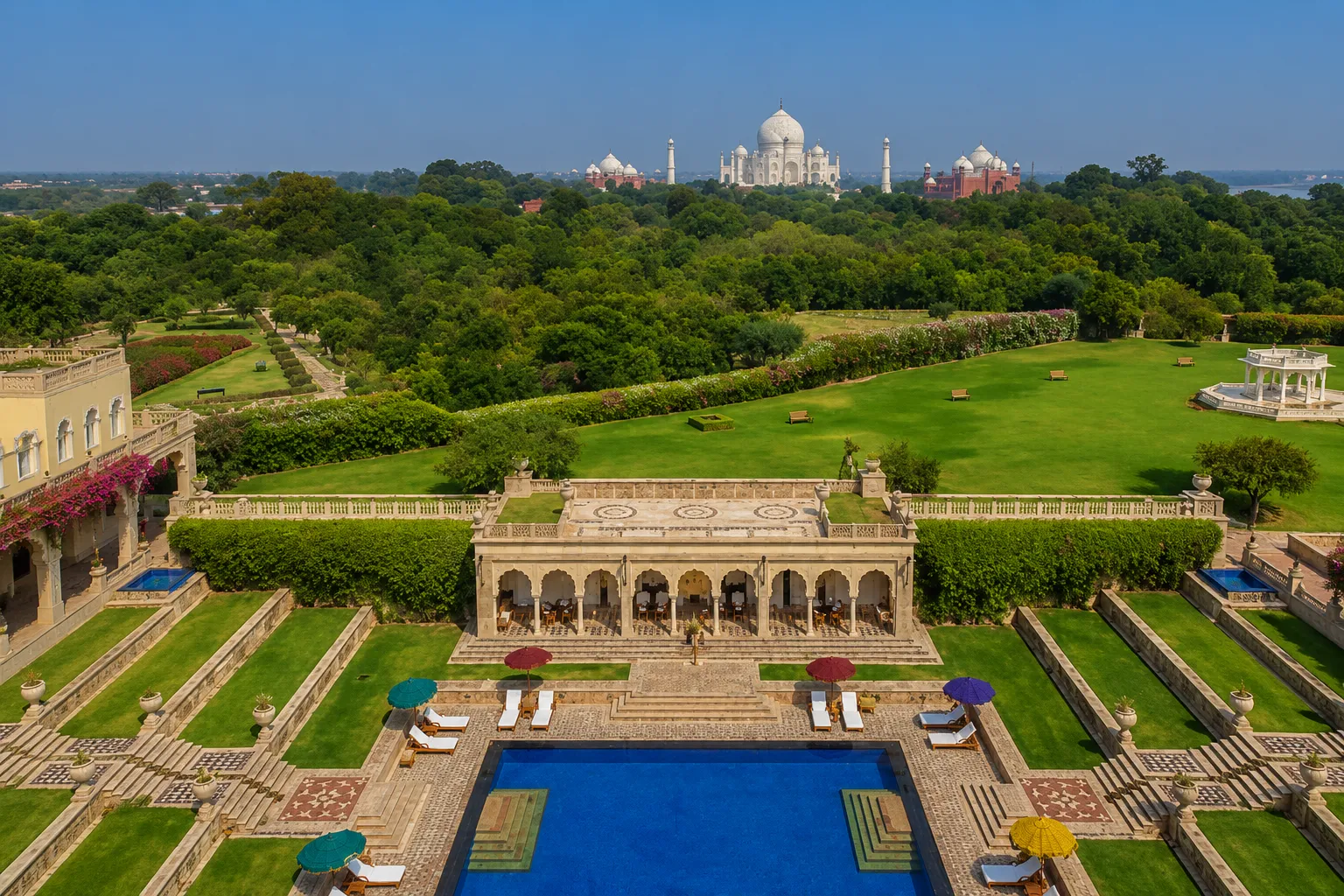 A beautifully illuminated tiered swimming pool at night surrounded by palatial Mughal architecture at The Oberoi Amarvilas, Agra.