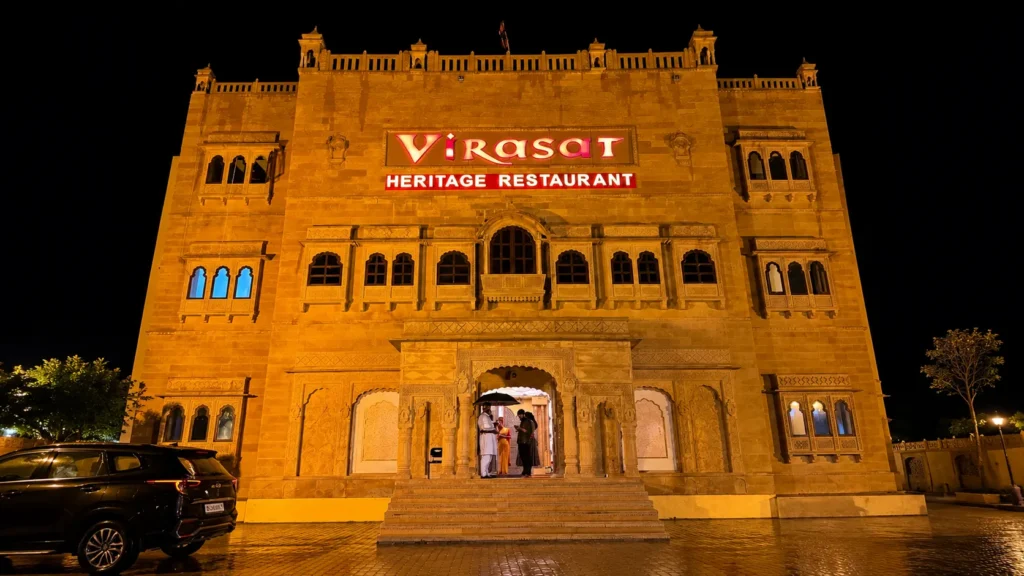 Virasat Heritage Restaurant, Jaipur 1 Night view of Virasat Heritage Restaurant in Jaipur featuring magnificent sandstone architecture, traditional Rajasthani design, ornate carvings, and a beautifully illuminated heritage façade.