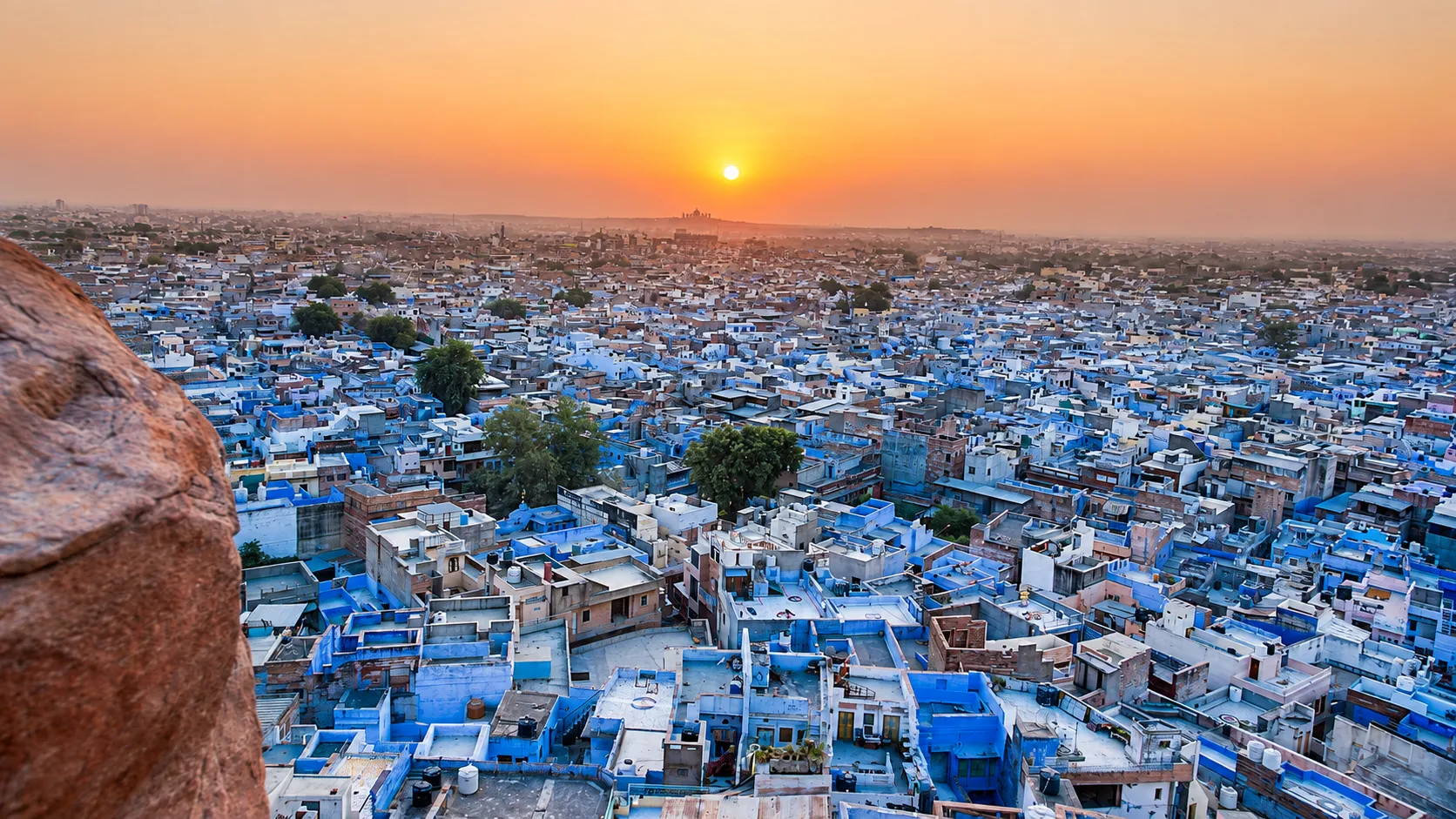 Panoramic view of Jodhpur's blue-painted houses spreading across the city at sunset