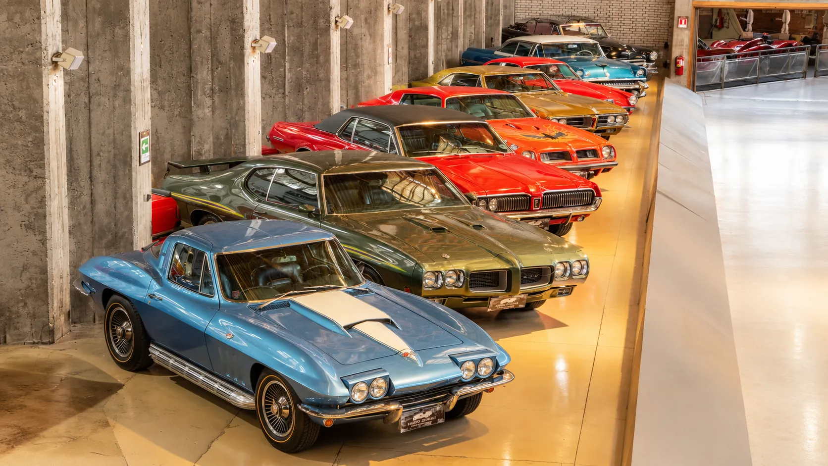 Collection of beautifully preserved vintage classic cars displayed inside a car museum