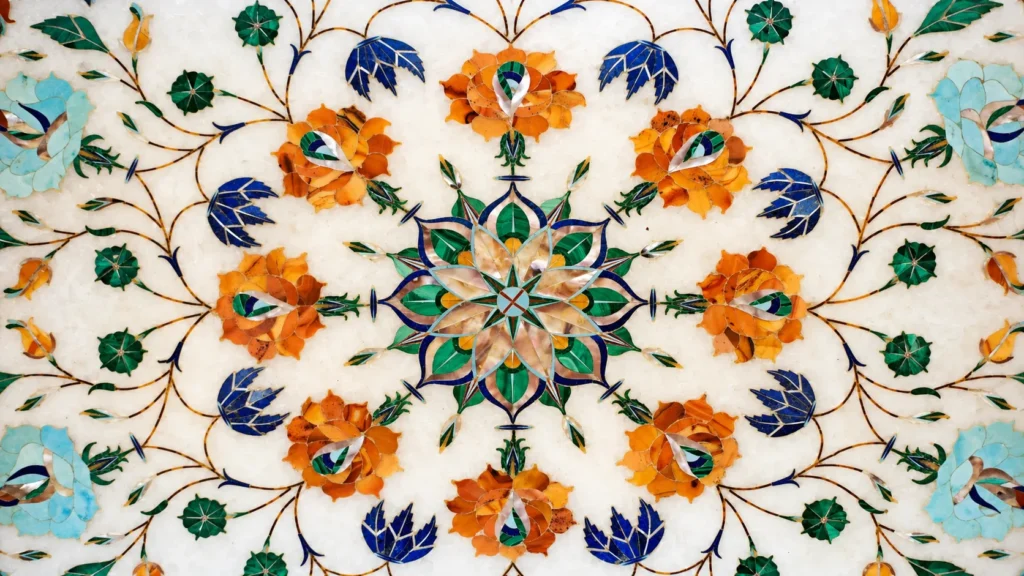 Symmetrical floral design featuring colourful semi-precious stone inlay set into an ivory marble surface