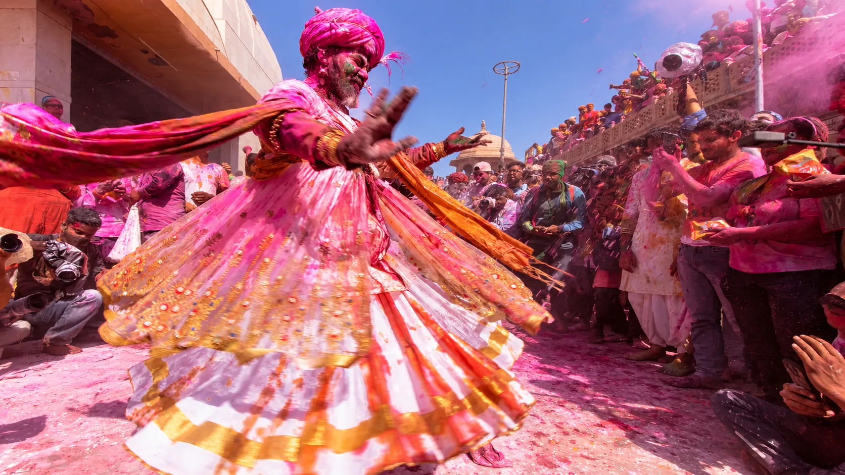 Traditional Holi celebration in Rajasthan with colourful powder, dancers and a festive crowd