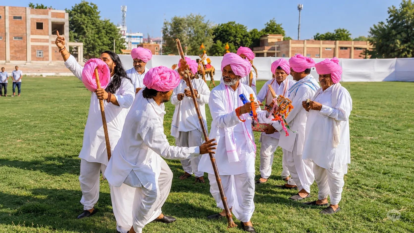 People celebrating Holi with vibrant colors and traditional folk dance during a festival in Rajasthan