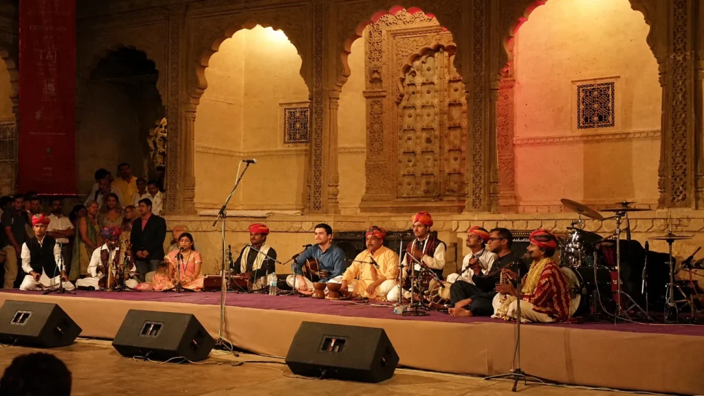 Rajasthan International Folk Festival 2026: Dates, Passes & Planning 1 Traditional Rajasthani musicians performing live at a cultural event in Rajasthan