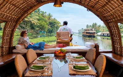 Travelers enjoying a relaxing Kerala houseboat journey through tropical backwaters