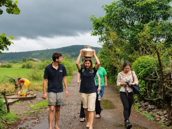 Travelers exploring a rural Indian village on a countryside walking tour